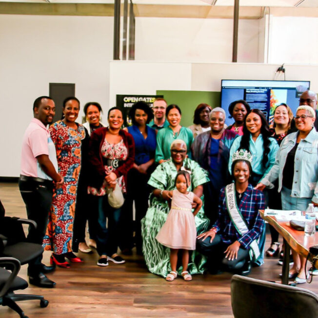 Group of happy smiling people at what looks like a conference or summit event.
